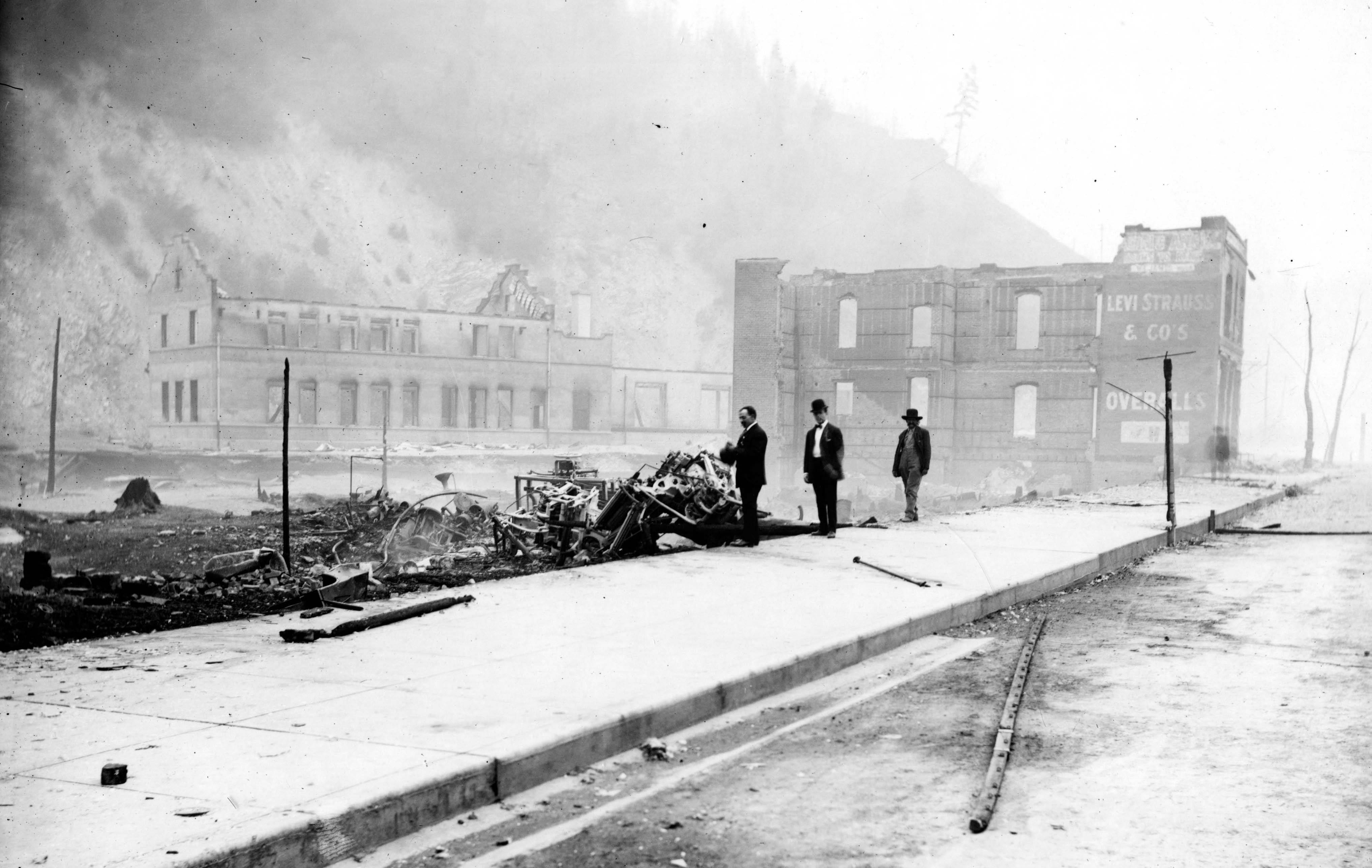 Forest Fire 1910 - Wallace, Idaho Remains of brick building at 721 Bank and, in background, O.R. & N depot, after fire of August 20.

