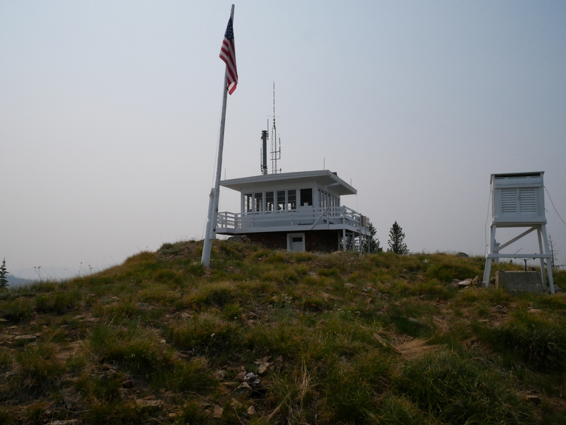 fire lookout tower with a flag pole and American flag