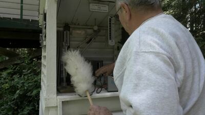 Ray Kresek gives the Keeping Watch team a tour of his fire lookout museum.