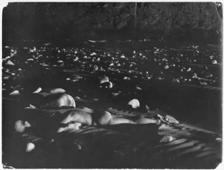 Katie Lee, lying in a bed of rocks