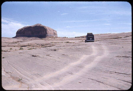 Car tracks across sandstone