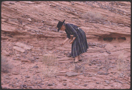 Georgia O'Keefe selecting stones on the shores of Lake Powell