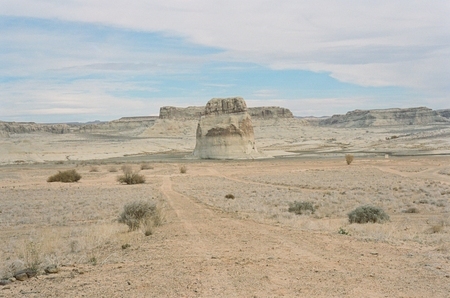 Vehicle tracks across Lake Powell's dry bed, heading to Lone Rock