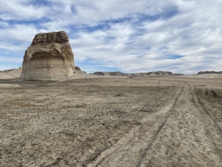 Tire tracks in Lake Powell's dry sediment beds at Lone Rock