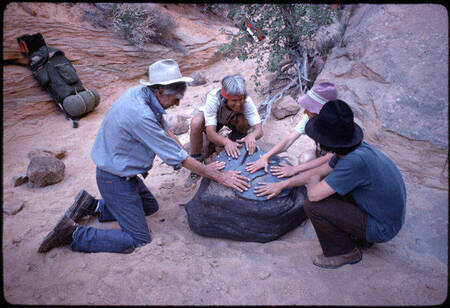 Visitors touching stone in Redbud Pass